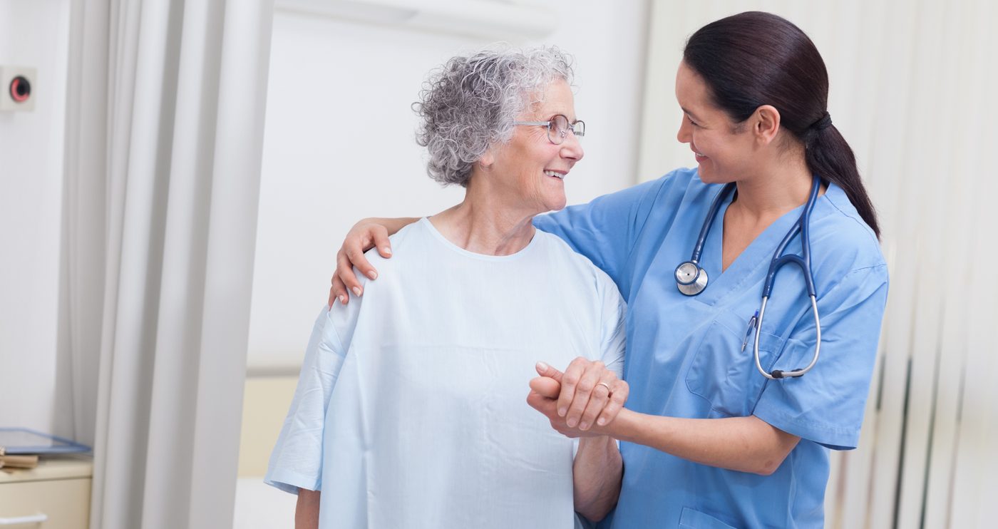 Holding the hand of an elderly hospice patient